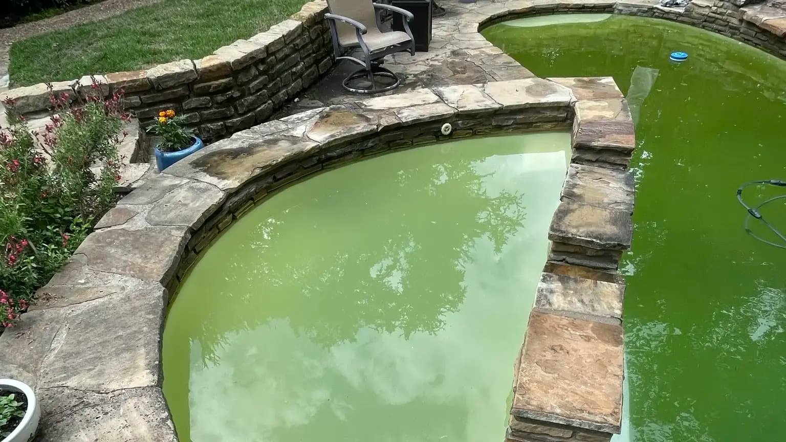 Connected spa and pool with pale green water before treatment